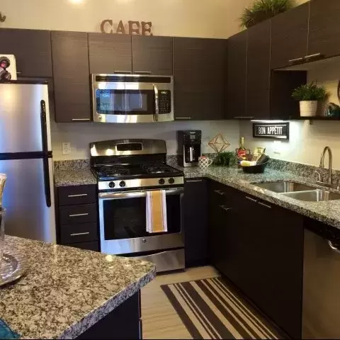 stocked kitchen of an apartment with stainless steel appliances